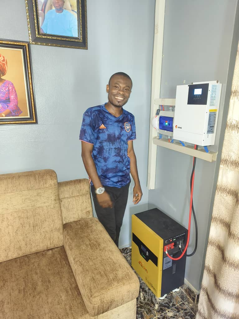 Technician beside a completed solar battery system