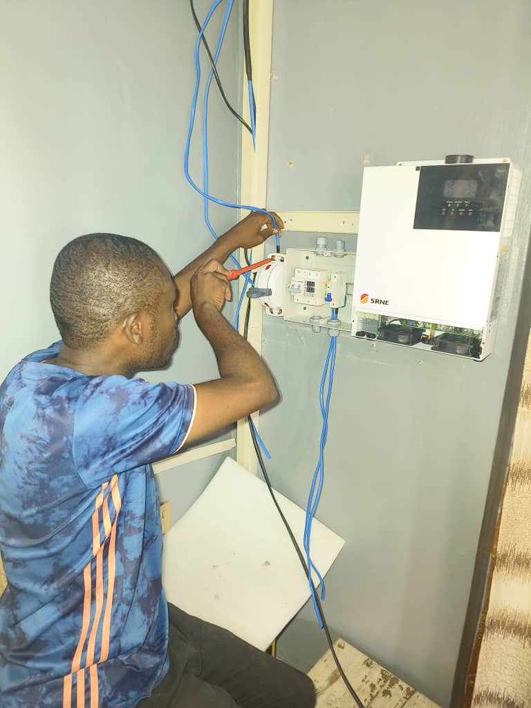 Briel Technologies technician beside a completed solar power system